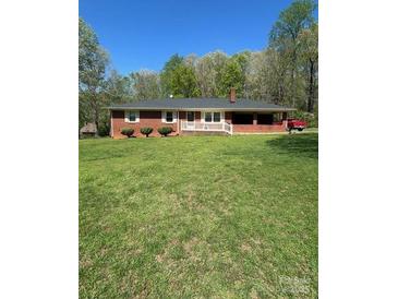 Charming single-story home with a brick exterior and a spacious front yard, perfect for outdoor activities at 215 Suncrest Rd, Cherryville, NC 28021