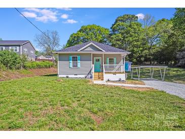 Charming single-story home with a small front porch, vibrant turquoise door and shutters, and a well-maintained lawn at 221 River Loop Rd, Belmont, NC 28012