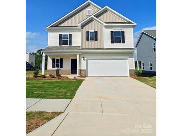 Charming two-story home with a well-manicured lawn and a two-car garage at 2231 Catawba Trace Dr, Catawba, NC 28609