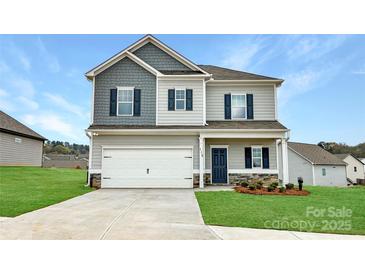Charming two-story home with a two-car garage, dark blue shutters, and landscaped front yard at 2231 Catawba Trace Dr, Catawba, NC 28609