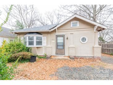 Charming bungalow-style home featuring a bay window, front door with glass, and a unique architectural details at 2616 Holton Ave, Charlotte, NC 28208