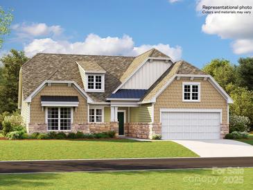 Charming single-Gathering home with stone accents, a lush green lawn, and an attached two-car garage at 4115 Camden Glen Rd, Lancaster, SC 29720