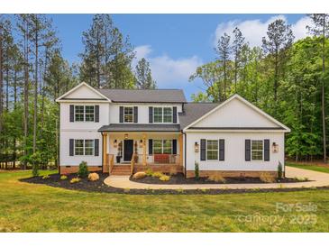 Charming two-story home with a welcoming front porch and beautifully landscaped front yard at 545 Morrison Farm Rd, Troutman, NC 28166