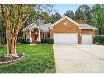 Charming brick home features an attached garage and well-manicured front lawn at 212 Kilborne Rd, Mooresville, NC 28117