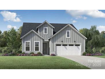 Charming craftsman-style home with gray siding, manicured lawn, and an attached two-car garage at 4158 Eastover Glen Rd # 0325, Charlotte, NC 28269