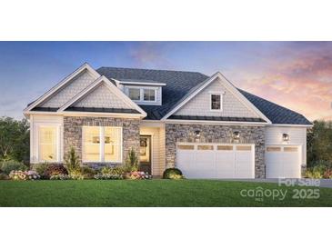 Charming single-story home showcasing a stone facade, dormer window, and a two-car garage at 5020 Mint Harbor Way # 0399, Charlotte, NC 28269