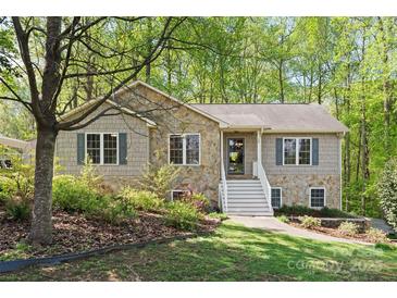 Charming two-story home featuring stone accents, complemented by lush greenery and a welcoming front entrance at 109 Wren Ln, Mooresville, NC 28117