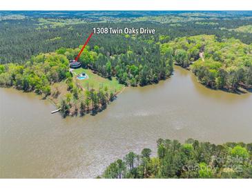 Stunning aerial view of waterfront home with a private pool on a wooded lot at 1308 Twin Oaks Dr, Chester, SC 29706