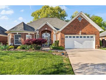 Beautiful brick home featuring an attached two-car garage and a well-maintained front lawn at 1511 Elkhart Cir, Gaston, NC 28054
