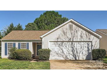 Charming single-story home with well-maintained landscaping and a two-car garage at 1807 Oakdale Green Dr, Charlotte, NC 28216