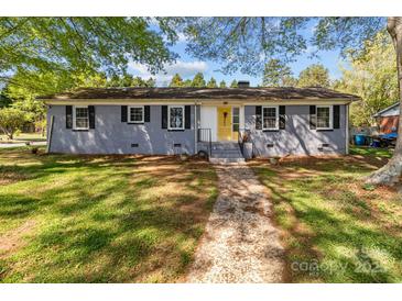 Charming single-story home with a gray brick exterior, black shutters, and a bright yellow front door at 1860 Rosemont St, Salisbury, NC 28144