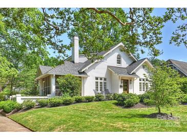 Charming white home featuring a chimney, a screened in porch, and a well-manicured lawn at 2101 Dilworth W Rd, Charlotte, NC 28203