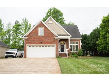 Charming brick home featuring a two-car garage and well-manicured lawn at 260 Ingonish Dr, Gastonia, NC 28056