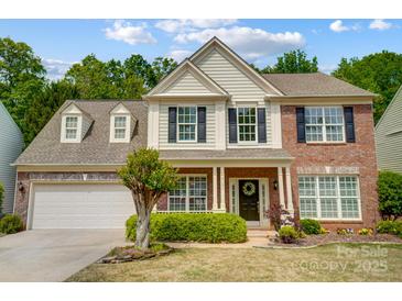 Charming two-story home with manicured lawn, traditional brick, and neutral siding at 3131 Arborhill Rd, Charlotte, NC 28270