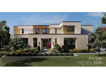 Modern home featuring a dramatic courtyard entry and contemporary stucco, siding, and black trim window design at 3630 Foxcroft Rd, Charlotte, NC 28211