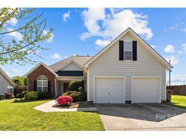 Charming home featuring a brick facade, two-car garage, and a well-manicured lawn at 4705 Granite Ct, Indian Trail, NC 28079