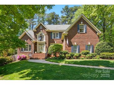 Charming two-story brick home with manicured lawn, walkway, and inviting entrance at 6009 Glen Manor Dr, Charlotte, NC 28269
