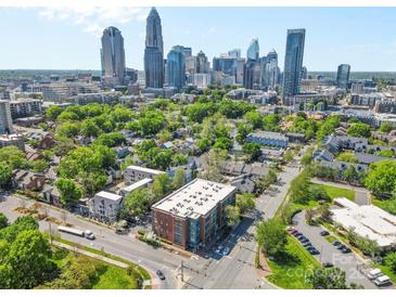 Stunning aerial view of a neighborhood near downtown with lush greenery and a glimpse of the city skyline at 626 N Graham St # 405, Charlotte, NC 28202