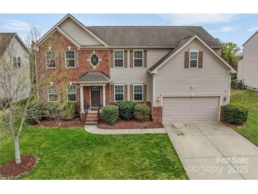 Charming two-story home featuring a brick facade, well-maintained lawn, and an attached two-car garage at 7362 Waterwheel Sw St # 280, Concord, NC 28025
