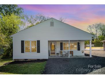 Charming home featuring a well maintained yard and covered front porch perfect for relaxing at 833 Old Charlotte Sw Rd, Concord, NC 28027