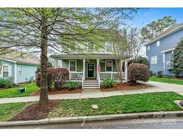 Charming two-story home with a welcoming front porch and well-maintained landscaping at 10210 Roosevelt Dr, Huntersville, NC 28078