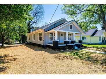Charming gray home featuring a welcoming front porch with black and white accents at 1143 N College Ave, Newton, NC 28658