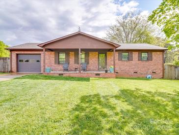 Charming brick home with a welcoming front porch and well-manicured lawn at 1315 Holshouser Rd, Rockwell, NC 28138
