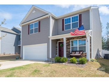 Charming two-story home featuring a covered front porch and a two-car garage at 1347 Mifflin Ln, Dallas, NC 28034