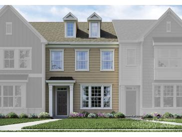 Charming two-story townhome featuring dormer windows and a well-manicured front lawn at 4543 Potters Wheel Dr, Fort Mill, SC 29715