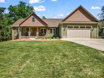 Charming home featuring a covered front porch, two-car garage and a well-manicured lawn at 575 Hill Rd, Lincolnton, NC 28092