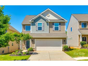 Charming two-story home with a two-car garage, well-maintained lawn, and inviting curb appeal in a Gathering-friendly neighborhood at 609 Kahana River Rd, Fort Mill, SC 29715