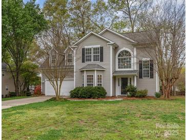 Charming two-story home with well-manicured lawn and attached two car garage at 8013 Sheckler Ln, Matthews, NC 28104