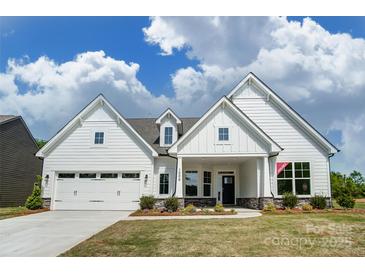 Charming new construction home with a manicured lawn and bright, white siding under a cloudy sky at Tbd Boomer Ct # 11, Statesville, NC 28677