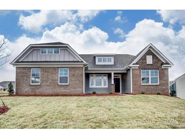 Beautiful brick and siding home featuring a well-manicured lawn and classic architectural details at Tbd Boomer Ct # 12, Statesville, NC 28677