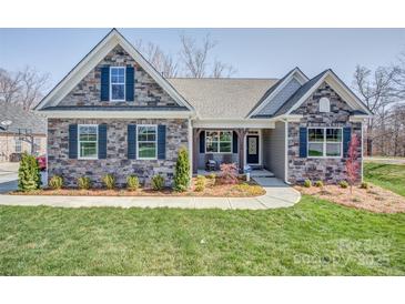 Charming single-story home with stone facade, blue shutters, covered porch, and well-manicured lawn at Tbd Boomer Ct # 12, Statesville, NC 28677