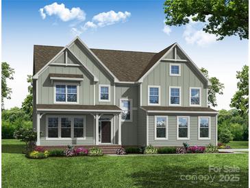 Charming two-story home with board and batten siding, a cozy front porch, and meticulously landscaped front yard at Tbd Boomer Ct # 8, Statesville, NC 28677