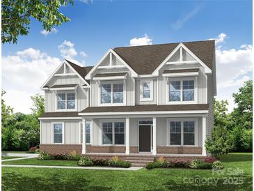 New construction two story home with craftsman details, three gables, covered porch, and brick accents at Tbd Boomer Ct # 9, Statesville, NC 28677