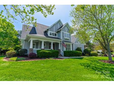Charming gray two-story home with a welcoming front porch and lush green lawn at 125 Swayne Dr, Mooresville, NC 28117
