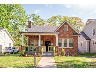 Charming brick home with a cozy front porch and well-maintained landscaping at 2221 Commonwealth Ave, Charlotte, NC 28205