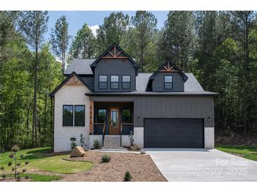 Charming two-story home featuring a modern facade, lush landscaping, and inviting front entrance at 6265 Riviera Run Estates Dr, Hickory, NC 28601