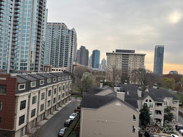 Elevated view of the city skyline and rooftops of condominiums on a cloudy day at 715 N Church St # 613, Charlotte, NC 28202