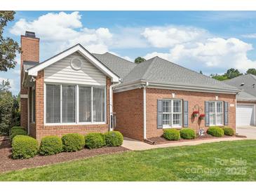 Charming brick home with manicured lawn, well-kept landscaping, and inviting curb appeal at 11346 Olde Turnbury Ct, Charlotte, NC 28277