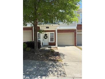Charming townhome with a one-car garage and a welcoming front door adorned with a wreath at 14208 Castle Abbey Ln, Charlotte, NC 28277