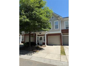 Charming townhome featuring a brick facade, an attached garage and a welcoming front entrance at 14208 Castle Abbey Ln, Charlotte, NC 28277