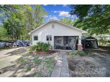 Charming single-story home with a screened-in porch and beautifully landscaped front yard at 216 W 16Th St, Kannapolis, NC 28081