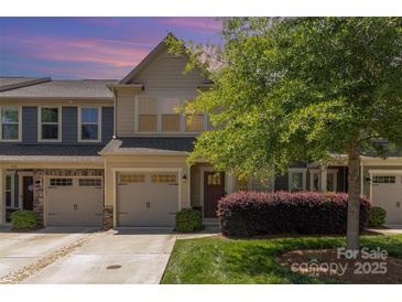 Charming townhome with a one-car garage, well-maintained lawn, and mature landscaping at 226 Scenic View Ln, Matthews, NC 28104