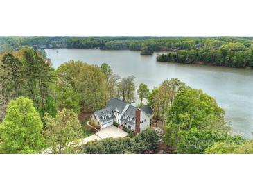 Stunning aerial view of lakeside home with lush greenery and a private, serene setting at 272 Harbor Ridge Dr, Statesville, NC 28677