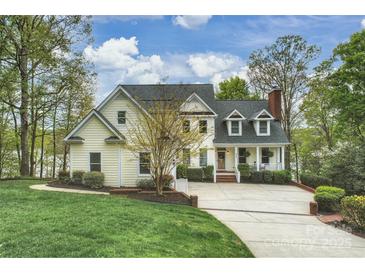Inviting two-story traditional home with a charming front porch and well-manicured lawn and a private drive at 272 Harbor Ridge Dr, Statesville, NC 28677