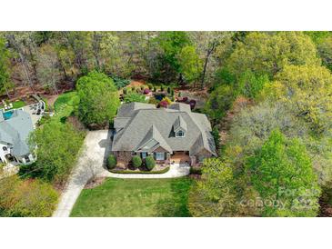 Stunning aerial view of a home featuring mature trees and a manicured yard and brick exterior at 305 Caledonia Way, Waxhaw, NC 28173
