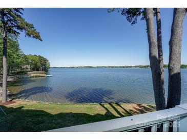 Expansive lake view from this home featuring a private dock and lush landscaping at 368 Northwest Dr, Davidson, NC 28036